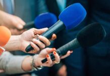 Zelenskyy Honors Musk With Huge Award Reporters holding colorful microphones