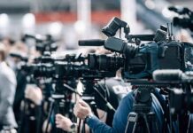 Runoff Shock: Norman Bows Fast Broadcast cameras on tripods at a press event