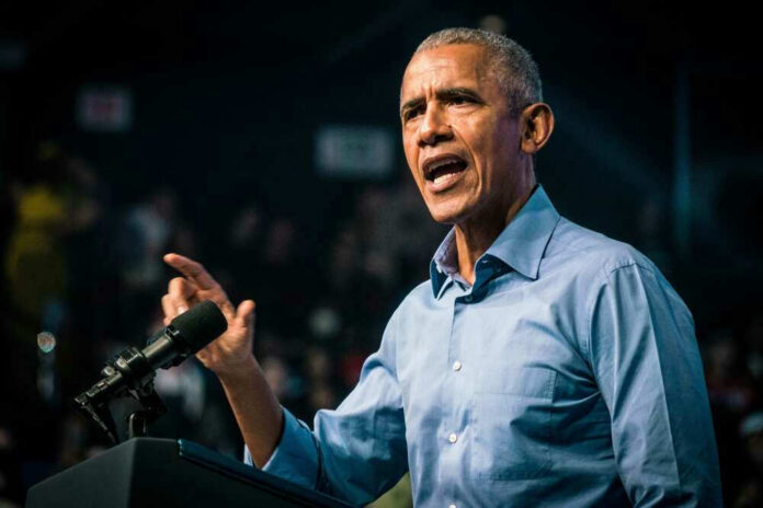 shutterstock_2230017639 Barack Obama speaks at podium.
