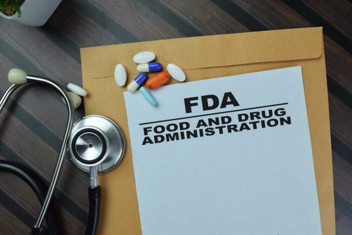 Concept,Of,Fda,-,Food,And,Drug,Administration,Write,On FDA document with pills and a stethoscope on a wooden surface