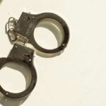 11-Year-Old Booked – Brother Found Murdered A pair of metallic handcuffs resting on a light surface