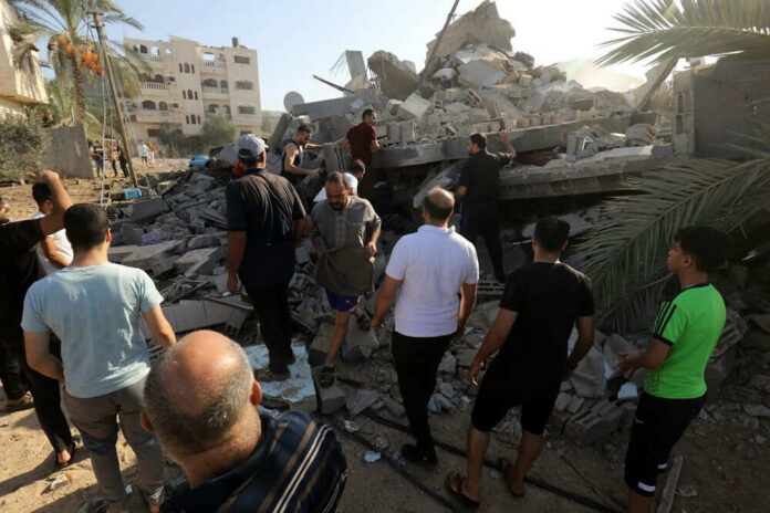People search through rubble of a collapsed building