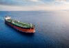 An oil tanker navigating through calm ocean waters