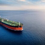 An oil tanker navigating through calm ocean waters