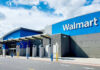 Retail Cage Match: Walmart vs. Amazon Walmart store entrance with blue skies above