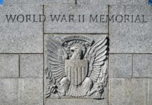 Sacred Monument Hit — Prosecutors Move Fast World War II Memorial stone wall with eagle emblem