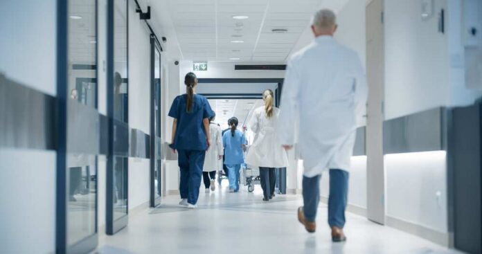 Medical staff walking through a hospital corridor
