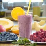 Popular Drink Chain’s Bold Reboot – 1800 Locations! Berry smoothie in a glass with orange slice and straws