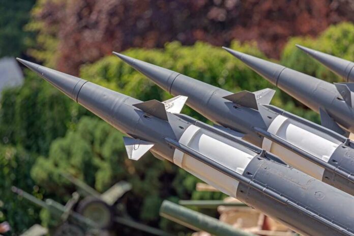 Multi,Rockets,Missile,Launcher,Air,Defense,System,In,Front,Of Close-up of multiple gray missiles with pointed noses and fins