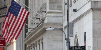 American flag outside a marble building on Wall Street