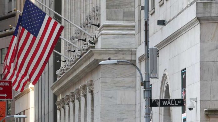American flag outside a marble building on Wall Street
