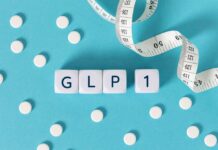 GLP-1 Linked to Sudden Blindness?! GLP-1 cubes with pills and a measuring tape on blue background