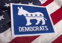 Dems Get Poll Shock Democrats emblem on an American flag background.