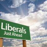 Lib Craziness: Word Swap Sparks Firestorm Green roadside sign against a cloudy sky