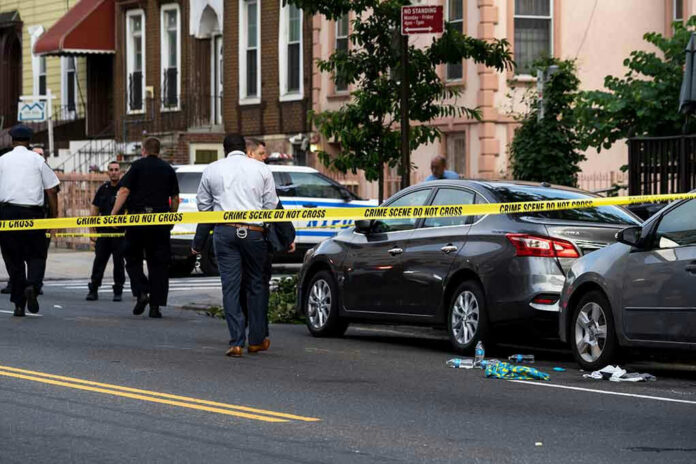 Police and crime scene tape on city street.