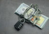 Dead Paychecks Stopped Cold A stack of cash secured with a chain and padlock