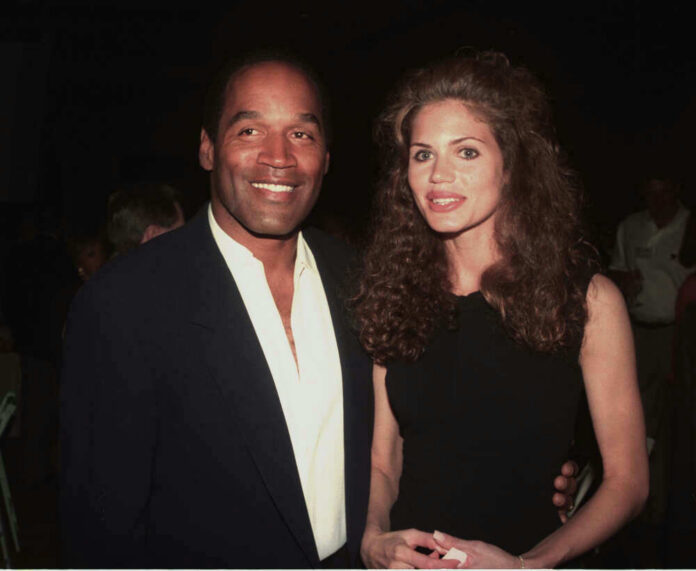 O. J. Simpson and Paula Barbieri posing together at an event