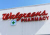 Signs for Walgreens and Pharmacy on building facade
