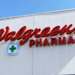 Signs for Walgreens and Pharmacy on building facade