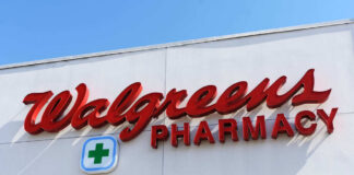 Signs for Walgreens and Pharmacy on building facade