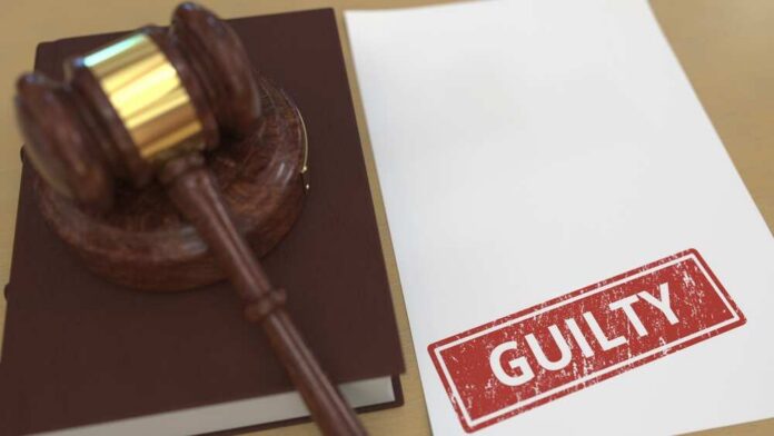 Judge’s gavel on a book beside a paper stamped guilty