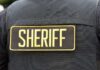 Close-up of a sheriff's uniform with a badge