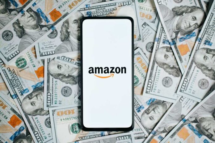 Amazon,American,Company,Logo,On,Screen,Of,Mobile,Phone,Lying Smartphone with Amazon logo on screen over US hundred-dollar bills