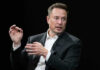 Elon Musk in a suit talking.