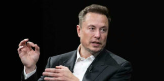 Elon Musk in a suit talking.