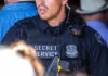 Secret Service officer in tactical vest with radio and badge