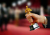 Hand holding an Oscar award