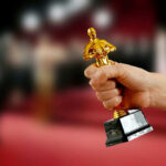 Hand holding an Oscar award