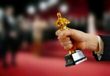 Oscar On Day One? Hand holding an Oscar award