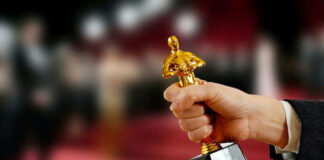 Hand holding an Oscar award