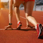 Athlete on starting line of a track.