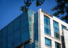 Modern office building with Amazon logo against sky
