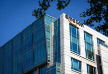 Modern office building with Amazon logo against sky
