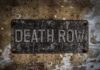 Death Row Over Children Deaths Weathered metal sign reading 'DEATH ROW' on a wall