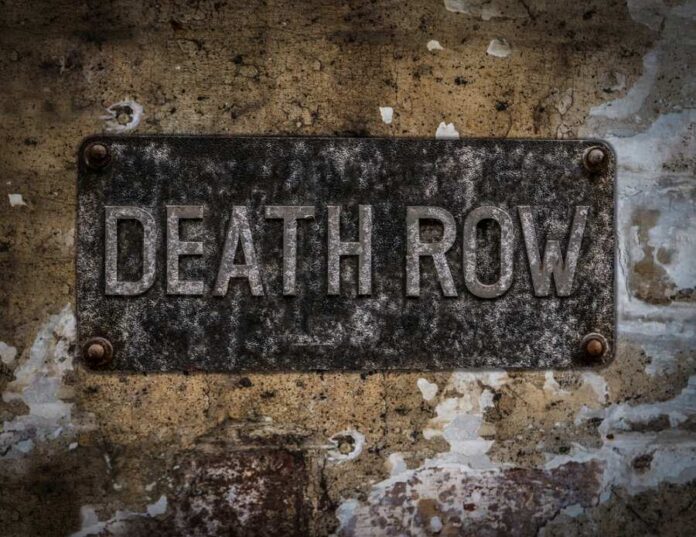 shutterstock_533872477 Weathered metal sign reading 'DEATH ROW' on a wall